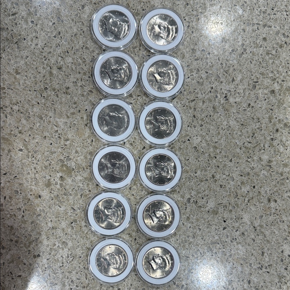 12- Mint condition Half Dollar(Some Toners) Silver Coin Set in Clear Holders